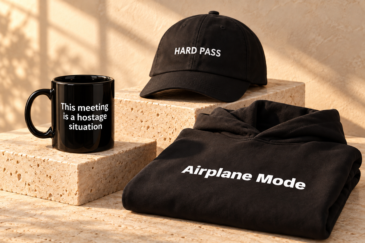 Blunt black mug, embroidered hat and hoodie styled on warm stone